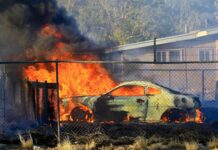 Car torched, homes threatened